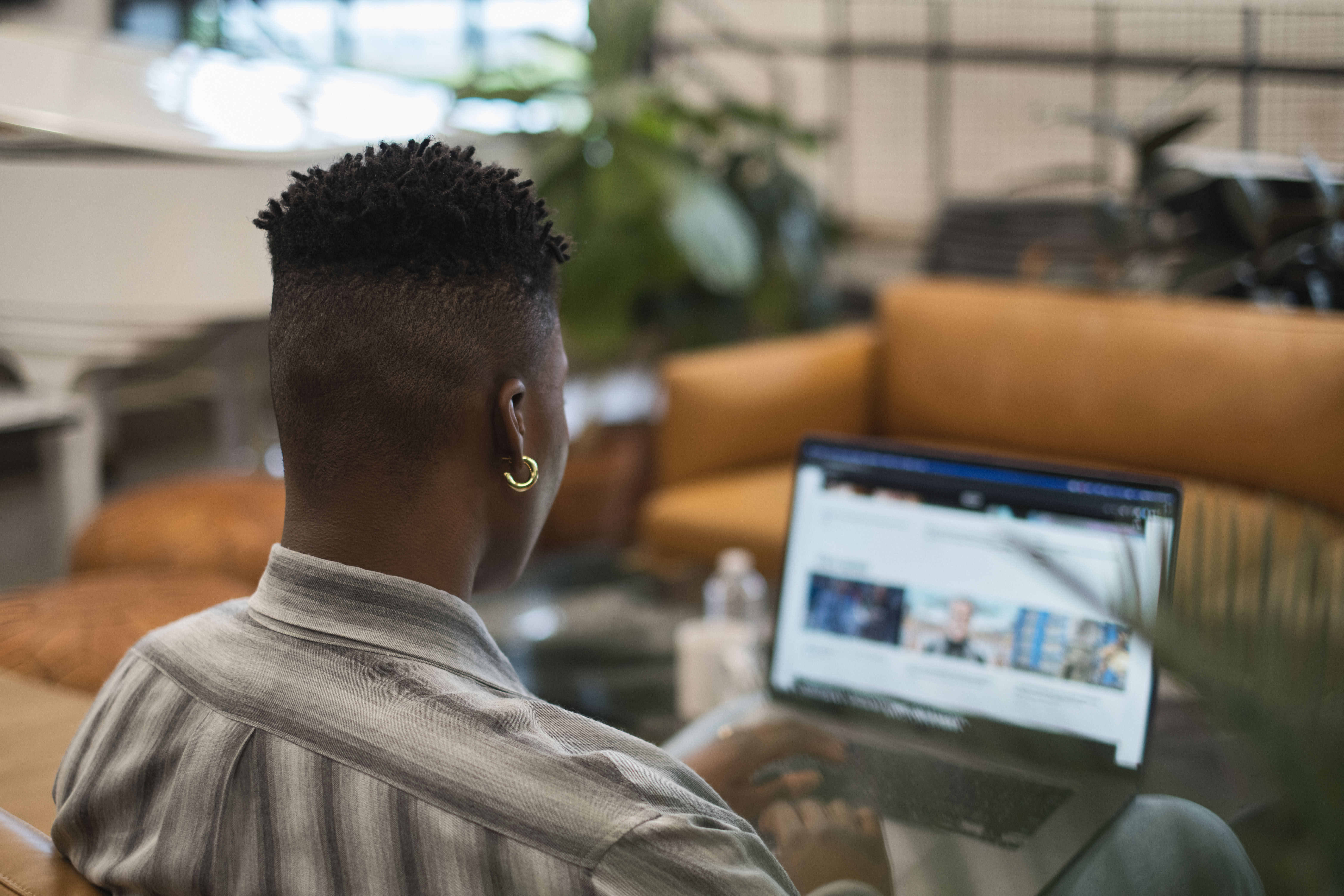 A non-binary person using a laptop at work(3)